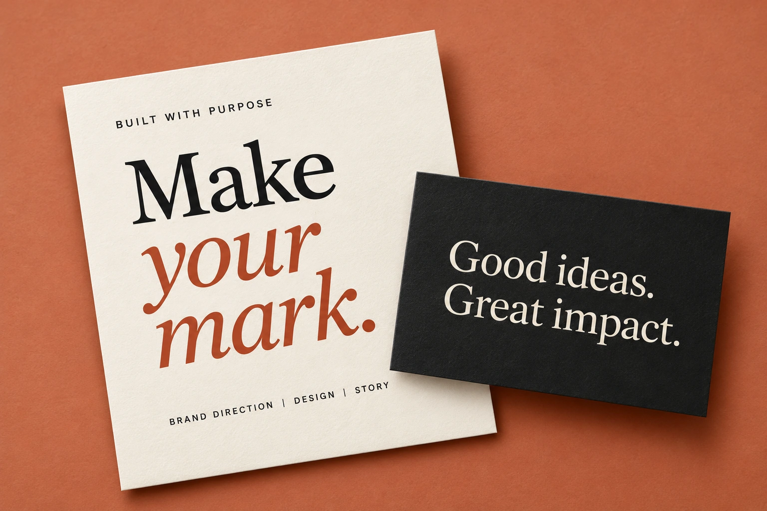 Cream stationery and charcoal brand card on a terracotta surface